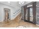 Grand foyer with decorative tile flooring, staircase, and ornate front doors at 3675 N 59Th Pl, Phoenix, AZ 85018