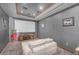 A cozy home theater featuring a large projection screen, comfortable seating, and a classic popcorn machine at 3675 N 59Th Pl, Phoenix, AZ 85018