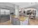 Open kitchen featuring stainless appliances, gray cabinets, island with barstool seating, and great sight lines at 3675 N 59Th Pl, Phoenix, AZ 85018