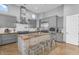 Modern kitchen featuring gray cabinetry, a large island with seating, and stainless steel appliances at 3675 N 59Th Pl, Phoenix, AZ 85018