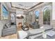 Cozy living room featuring a fireplace, stone accent walls, and multiple arched windows at 3675 N 59Th Pl, Phoenix, AZ 85018