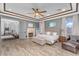 Luxurious main bedroom with a fireplace, sitting area, and wood-look flooring at 3675 N 59Th Pl, Phoenix, AZ 85018