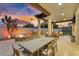 Inviting outdoor area with a full dining table, a built-in grill, a fire pit, and covered patio at 3675 N 59Th Pl, Phoenix, AZ 85018