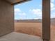 View of the expansive, blank canvas backyard from the covered patio at 37215 W Patterson St, Maricopa, AZ 85138