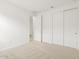 Carpeted bedroom with closet, white walls, and access to another room at 37215 W Patterson St, Maricopa, AZ 85138