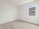 Comfortable bedroom with neutral carpet, window view, and ample natural light at 37215 W Patterson St, Maricopa, AZ 85138