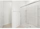Modern bathroom featuring a glass-enclosed shower with built-in shelving at 37215 W Patterson St, Maricopa, AZ 85138