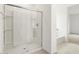 Modern bathroom showcasing a glass shower, built-in shelves, and a soaking tub at 37215 W Patterson St, Maricopa, AZ 85138