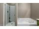 Modern bathroom featuring a separate shower and soaking tub, perfect for relaxation and comfort at 37384 W Prado St, Maricopa, AZ 85138