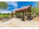 Community park featuring a picnic shelter with stone columns, picnic tables and a bike rack at 37384 W Prado St, Maricopa, AZ 85138