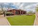 Expansive backyard with manicured lawn, covered patio, and meticulous landscaping, perfect for entertaining at 3816 E Expedition Way, Phoenix, AZ 85050