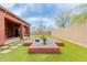 Lush backyard featuring an extended patio, impeccable landscaping, and privacy fencing at 3816 E Expedition Way, Phoenix, AZ 85050