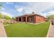 The backyard features a well-manicured lawn and cozy covered patio, perfect for outdoor enjoyment at 3816 E Expedition Way, Phoenix, AZ 85050