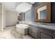 This bathroom features dual vanities, a soaking tub, travertine floors, and a glass block window at 3816 E Expedition Way, Phoenix, AZ 85050