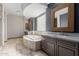 This bathroom features dual vanities, a soaking tub, travertine floors, and a glass block window at 3816 E Expedition Way, Phoenix, AZ 85050