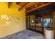 Aviano at Desert Ridge clubhouse entrance featuring glass doors, stone accents, and community signage at 3816 E Expedition Way, Phoenix, AZ 85050