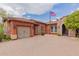 Charming single-story home with an American flag, manicured landscaping, brick accents, and a two-car garage at 3816 E Expedition Way, Phoenix, AZ 85050
