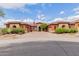 Stunning single-story home with desert landscaping and a circular brick driveway leading to attached garages at 3816 E Expedition Way, Phoenix, AZ 85050
