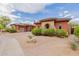 Attractive desert-landscaped home with colorful exterior, tile roof, and an attached garage at 3816 E Expedition Way, Phoenix, AZ 85050