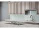 A stainless steel faucet sits above the kitchen island with custom cabinets and tiling at 3816 E Expedition Way, Phoenix, AZ 85050