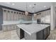 A large kitchen with a marble countertop island, stainless steel appliances, and custom cabinets at 3816 E Expedition Way, Phoenix, AZ 85050