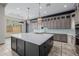 A large kitchen with a marble countertop island, stainless steel appliances, and custom cabinets at 3816 E Expedition Way, Phoenix, AZ 85050