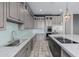 Spacious kitchen with stainless steel appliances, marble countertops, and a blue tile backsplash at 3816 E Expedition Way, Phoenix, AZ 85050