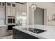 A large kitchen island with stainless steel appliances and gray cabinets in a large home at 3816 E Expedition Way, Phoenix, AZ 85050
