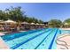 Inviting lap pool with clear water, lane markers, and poolside seating for swimmers and sunbathers at 3816 E Expedition Way, Phoenix, AZ 85050