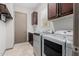 Functional laundry room equipped with modern washer, dryer, and ample storage space at 3816 E Expedition Way, Phoenix, AZ 85050