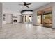 Large living room features a tiled fireplace, large windows, and tan tiled flooring at 3816 E Expedition Way, Phoenix, AZ 85050
