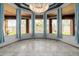 Living room showcasing expansive windows and travertine flooring, plus blue window coverings at 3816 E Expedition Way, Phoenix, AZ 85050