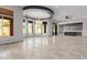 Spacious living room with tile flooring, large windows, and an adjacent kitchen at 3816 E Expedition Way, Phoenix, AZ 85050