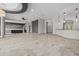 Open living room showing bar, living, and kitchen areas and tan tiled flooring at 3816 E Expedition Way, Phoenix, AZ 85050