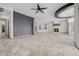 Bright, spacious living room featuring a ceiling fan, fireplace, and an open floor plan at 3816 E Expedition Way, Phoenix, AZ 85050