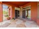 Covered patio with stone flooring, lush landscaping, and seamless indoor-outdoor living at 3816 E Expedition Way, Phoenix, AZ 85050