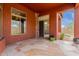 Covered patio featuring tile flooring, stone accents and large windows overlooking the lush landscaping at 3816 E Expedition Way, Phoenix, AZ 85050