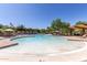 Resort-style pool area with ample lounge seating, umbrellas, and lush landscaping for relaxation at 3816 E Expedition Way, Phoenix, AZ 85050