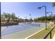 Outdoor tennis court with blue and green surface, net, and surrounding landscaping for recreational play at 3816 E Expedition Way, Phoenix, AZ 85050
