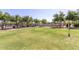 Outdoor volleyball court with green grass, a net, and bordered by trees creating a great place to play at 3816 E Expedition Way, Phoenix, AZ 85050