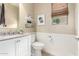 Cozy half bathroom with white wainscoting, stylish decor, and natural light at 3940 E Geronimo St, Gilbert, AZ 85295