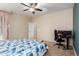 Bright bedroom featuring a ceiling fan, workspace, and a blue and white patterned bedspread at 3940 E Geronimo St, Gilbert, AZ 85295