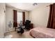 Functional bedroom features workout equipment, fan, and window with privacy blinds at 3940 E Geronimo St, Gilbert, AZ 85295