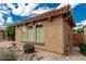 Close-up of a home's side exterior with beautiful windows, a tile roof, and desert landscaping at 3940 E Geronimo St, Gilbert, AZ 85295