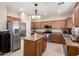 Kitchen with stainless steel appliances, central island and ample cabinet space at 3940 E Geronimo St, Gilbert, AZ 85295