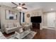 Inviting living room featuring a comfortable sofa, ceiling fan, and neutral decor at 3940 E Geronimo St, Gilbert, AZ 85295