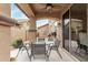 Covered patio has a ceiling fan and an outdoor dining set perfect for entertaining guests at 3940 E Geronimo St, Gilbert, AZ 85295