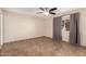 Spacious bedroom featuring tile flooring, ceiling fan, and a bright window for natural light at 4158 E Crescent Ave, Mesa, AZ 85206