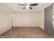 Spacious bedroom featuring neutral walls, ceiling fan, tiled flooring, and an entrance doorway at 4158 E Crescent Ave, Mesa, AZ 85206