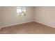 Cozy bedroom featuring tiled flooring, a large window, and light colored walls at 4158 E Crescent Ave, Mesa, AZ 85206